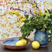 Rustic blue terracotta fruit bowl and vase with spring flowers